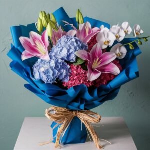 Blended bouquet with pink oriental lilies, blue hydrangeas, and white phalaenopsis orchids by Elandra Flowers, best flower shop in Dubai