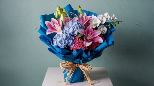 Blended bouquet with pink oriental lilies, blue hydrangeas, and white phalaenopsis orchids by Elandra Flowers, best flower shop in Dubai